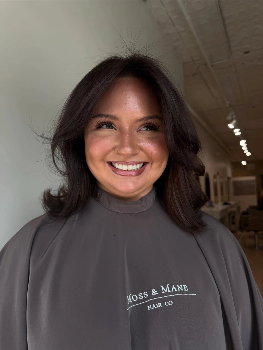 Medium-length dark brunette hair with curled face-framing layers
