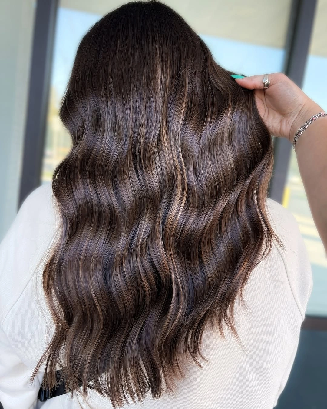 Back view of brunette waves with smoky light ribbons
