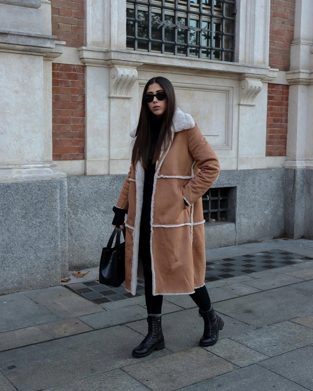 camel shearling-lined aviator, black layers, black knee boots and black bag