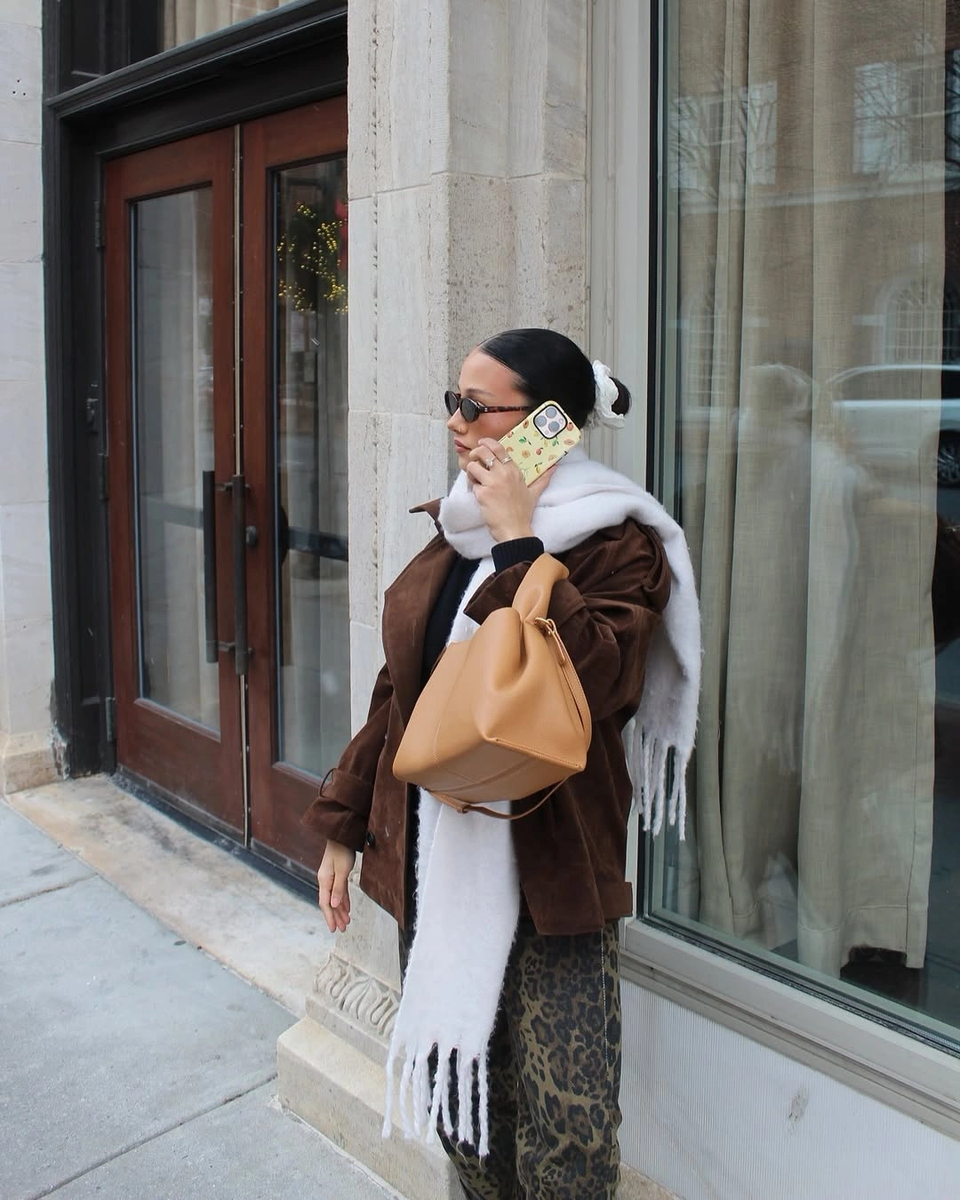 dark brown oversized scarf over patterned brown lower layers and tan bag