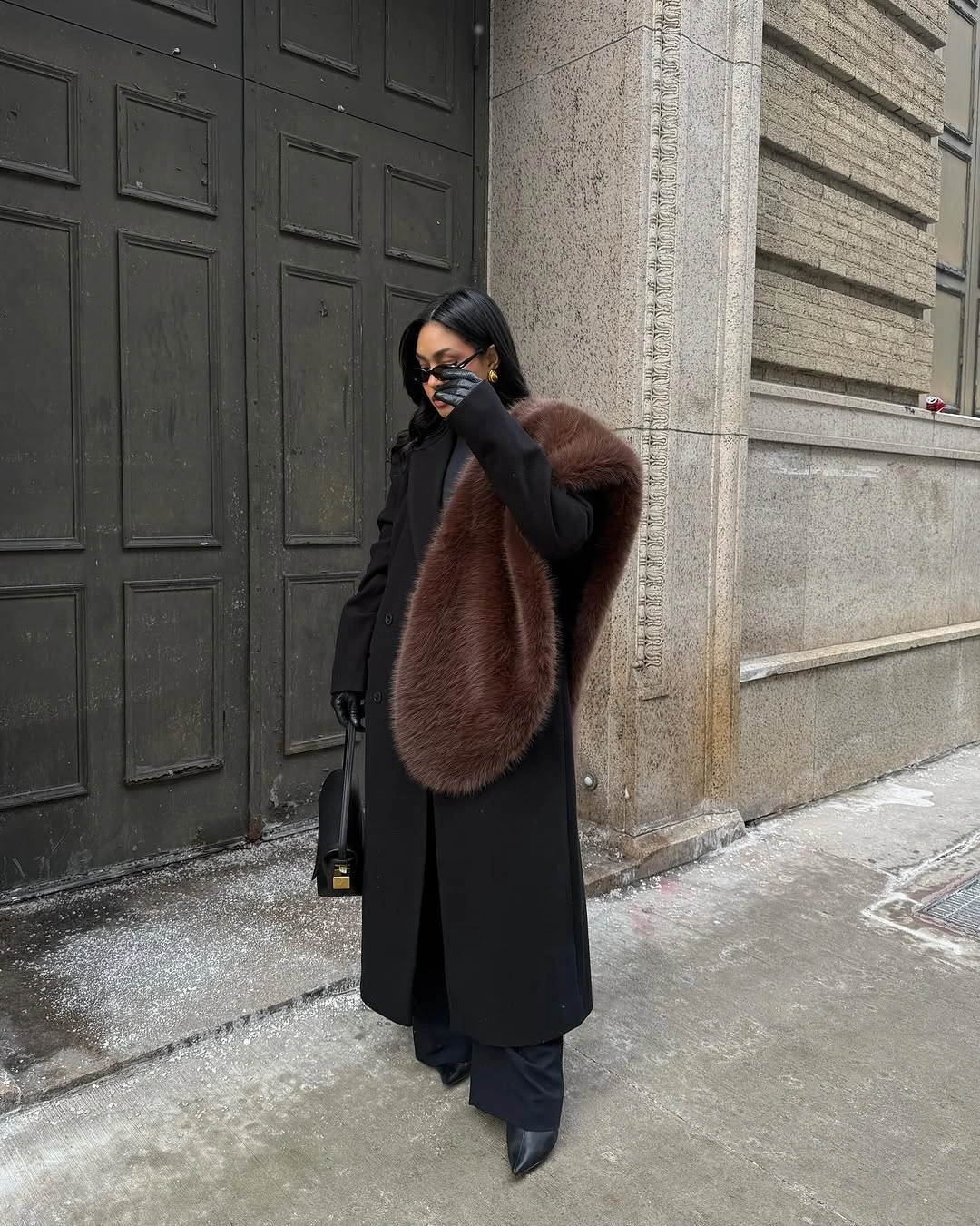 Long black coat and trousers with a brown fur stole