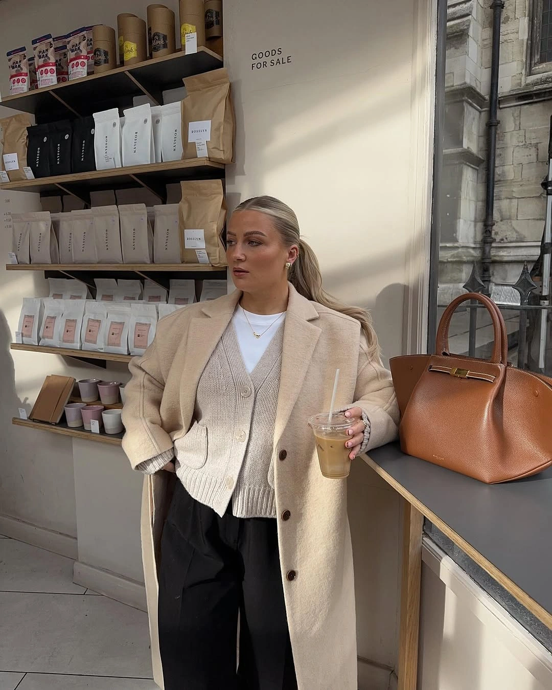 Beige outer layer with cream cardigan and wide black trousers