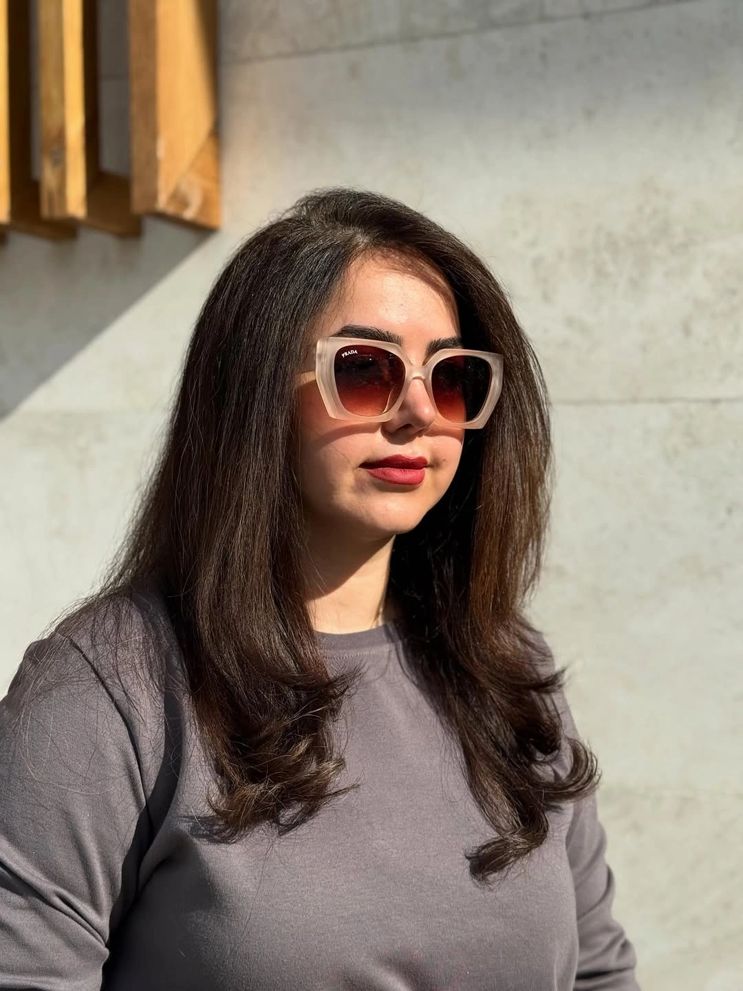 Long brown layered hair with side part and curled ends