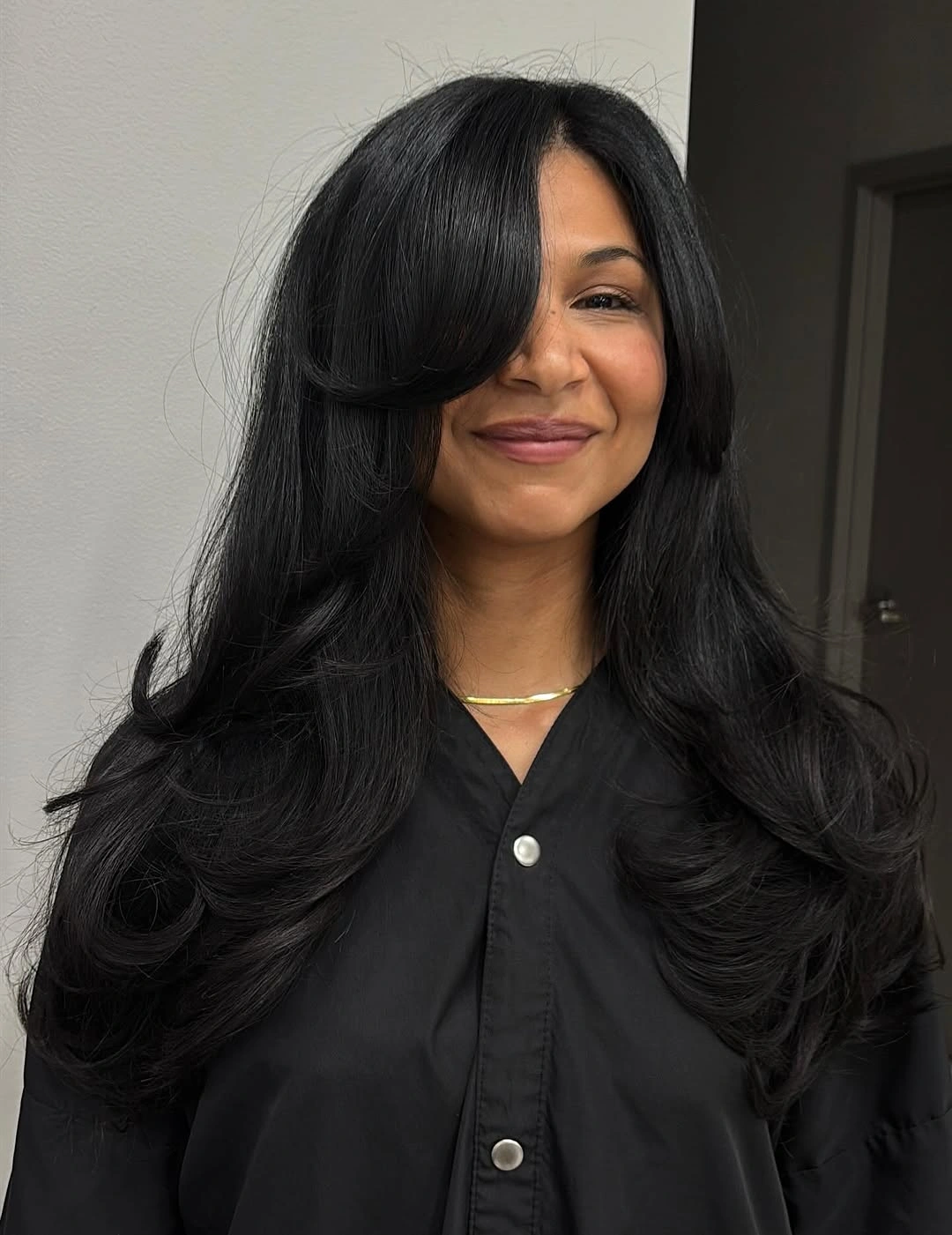 Long black layered hair with deep side part