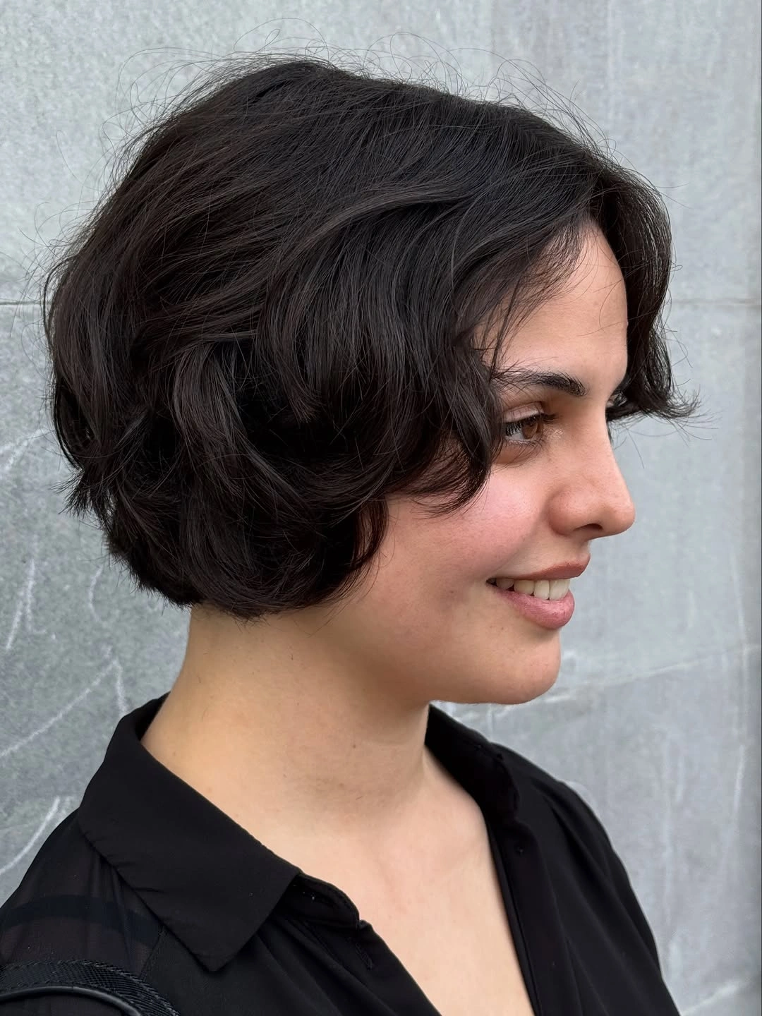 Short dark wavy bob with side part and exposed neck