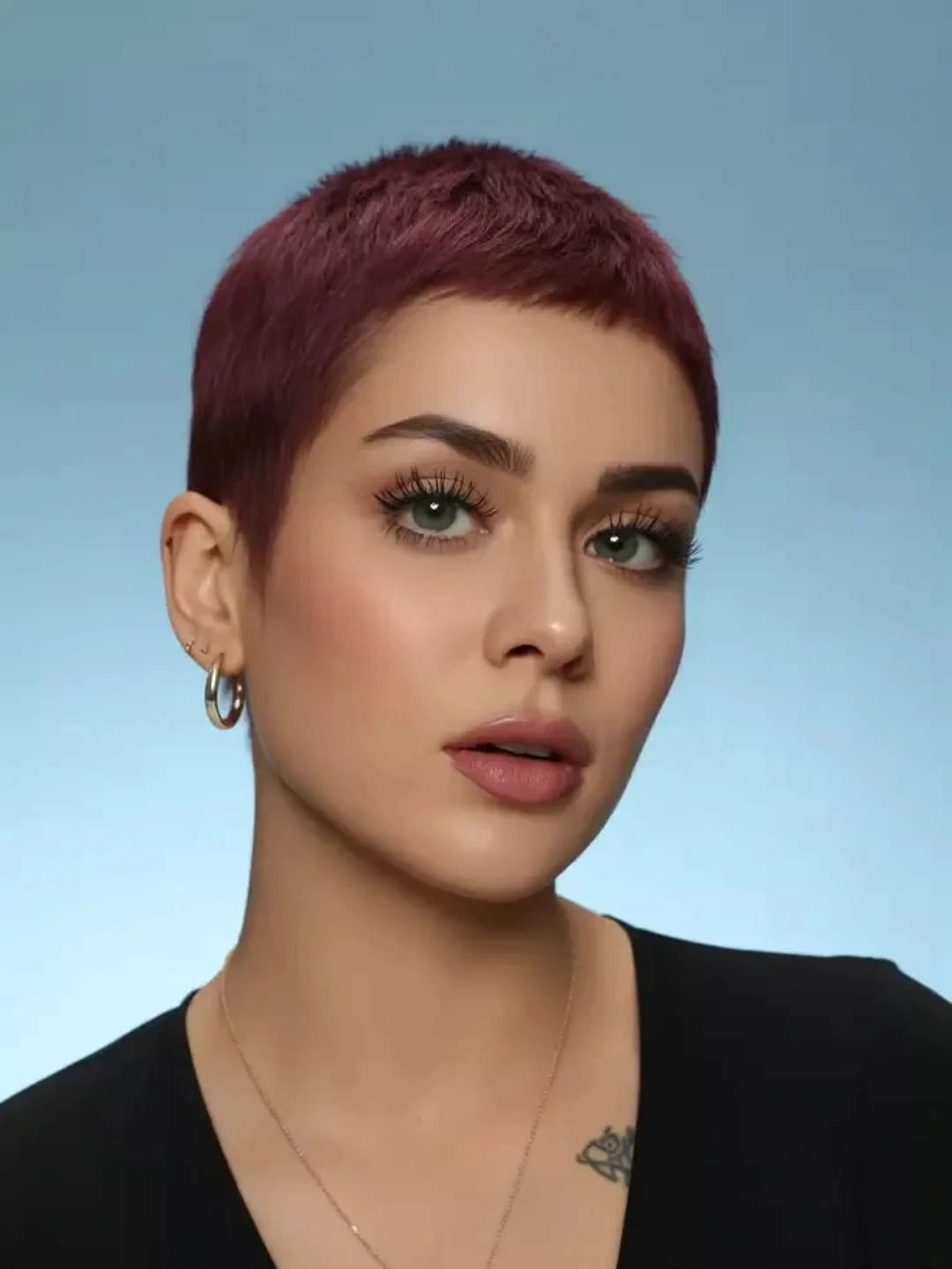 Very short burgundy pixie crop with exposed ears