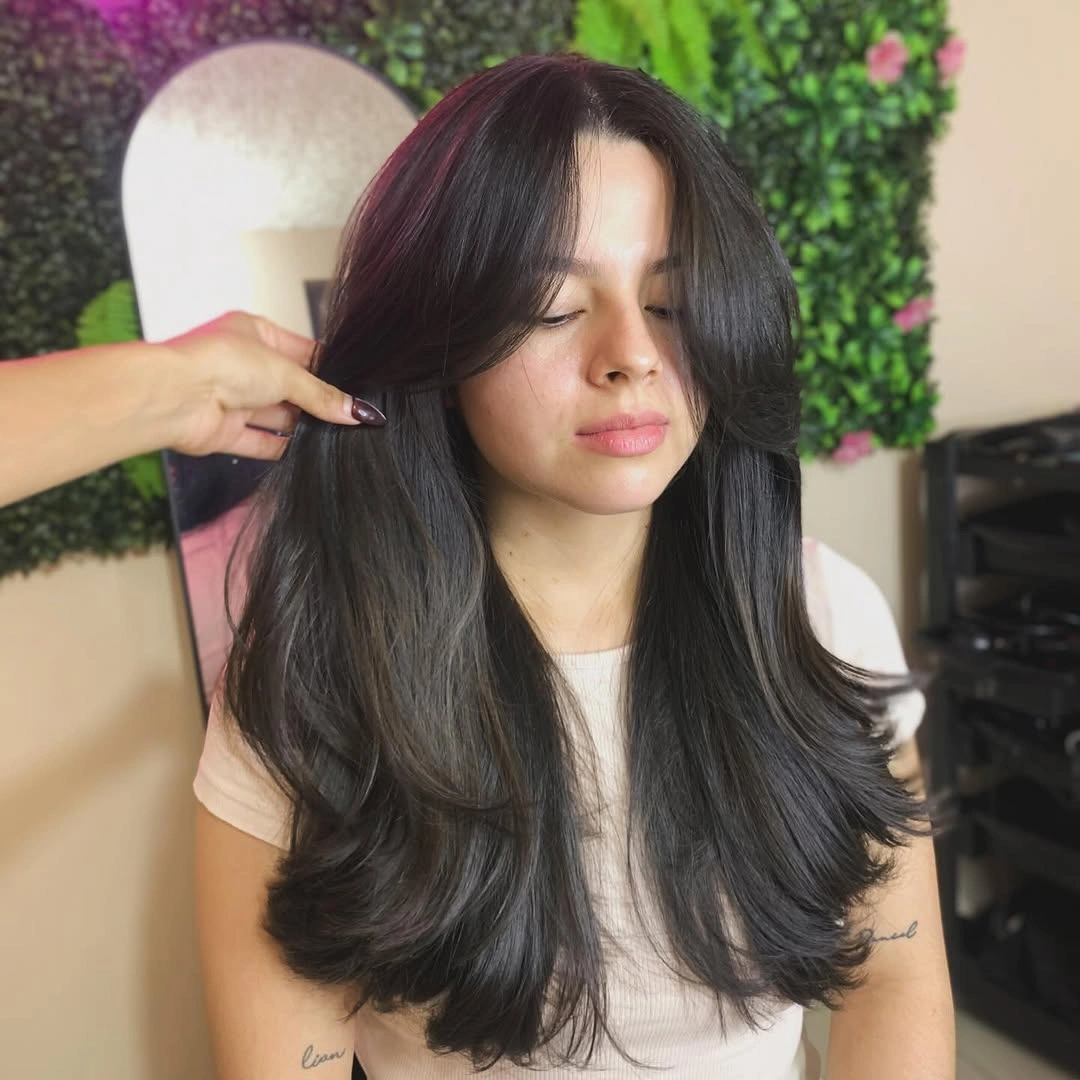 Long dark hair with curtain front pieces and curled ends