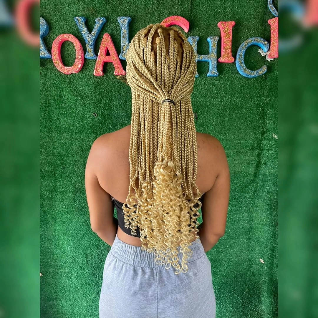 Light blonde braids gathered high with curly tail