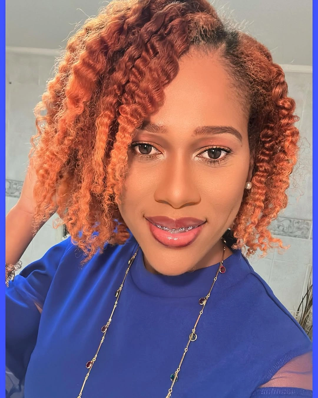 Copper curly-looking hair with short rounded shape