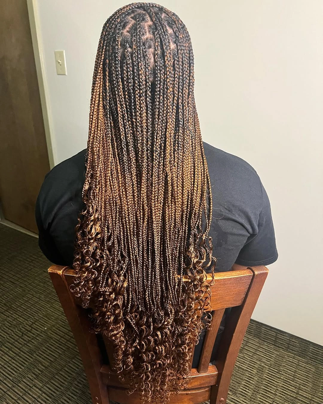 Very long thin brown braids ending in curls