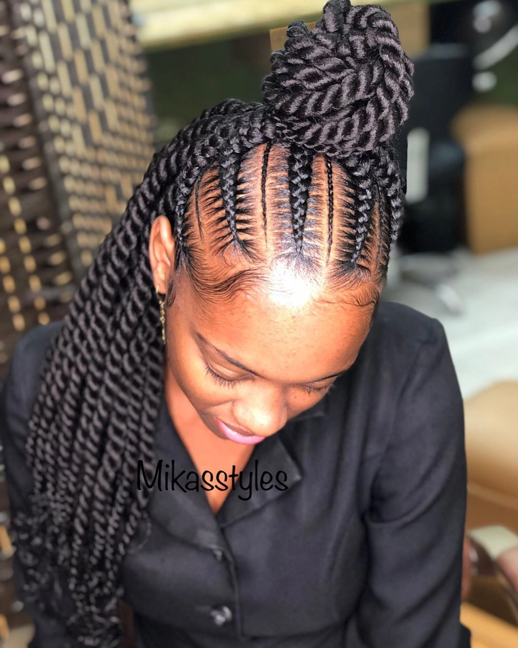 Thick black braids gathered into bun and long tail