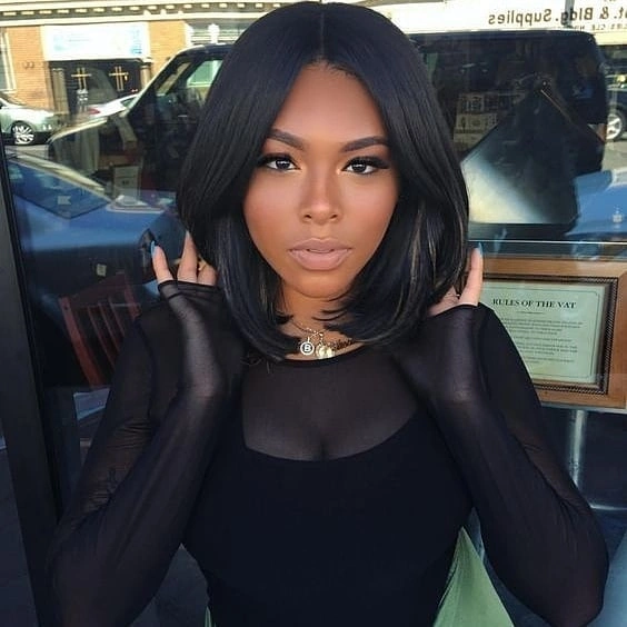 Sleek short black bob with center part and curved ends