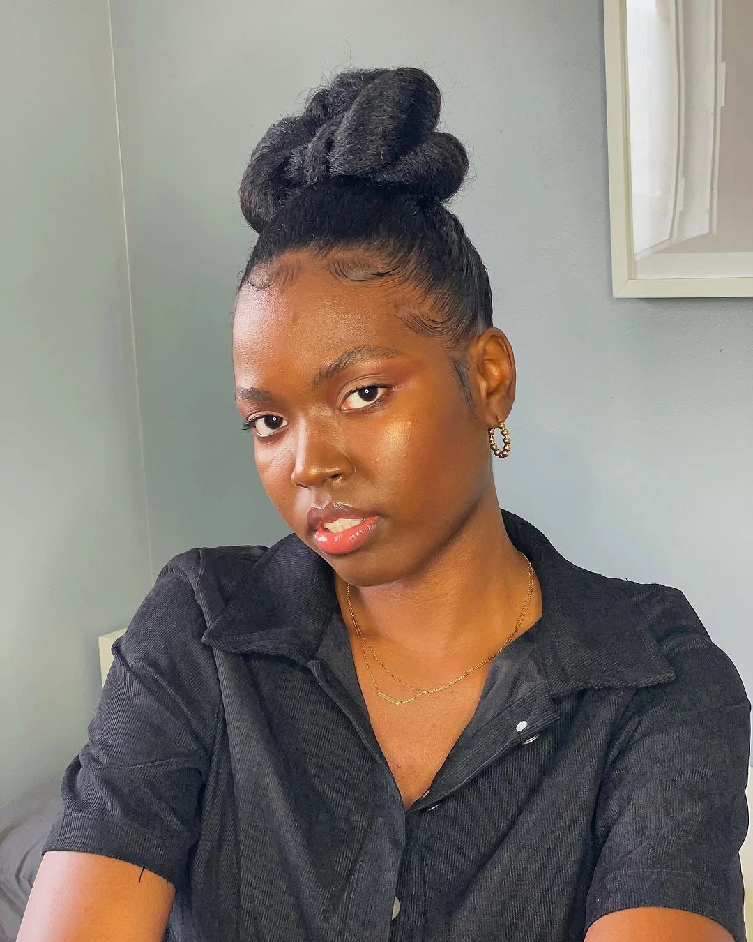 Smooth high bun with polished front and compact shape