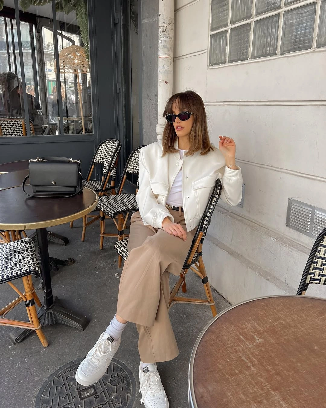 White cropped jacket, beige wide trousers, belt, and white sneakers