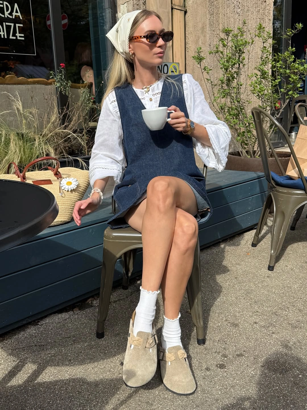 Denim blue dress-like layer, white blouse, pale socks, and taupe shoes