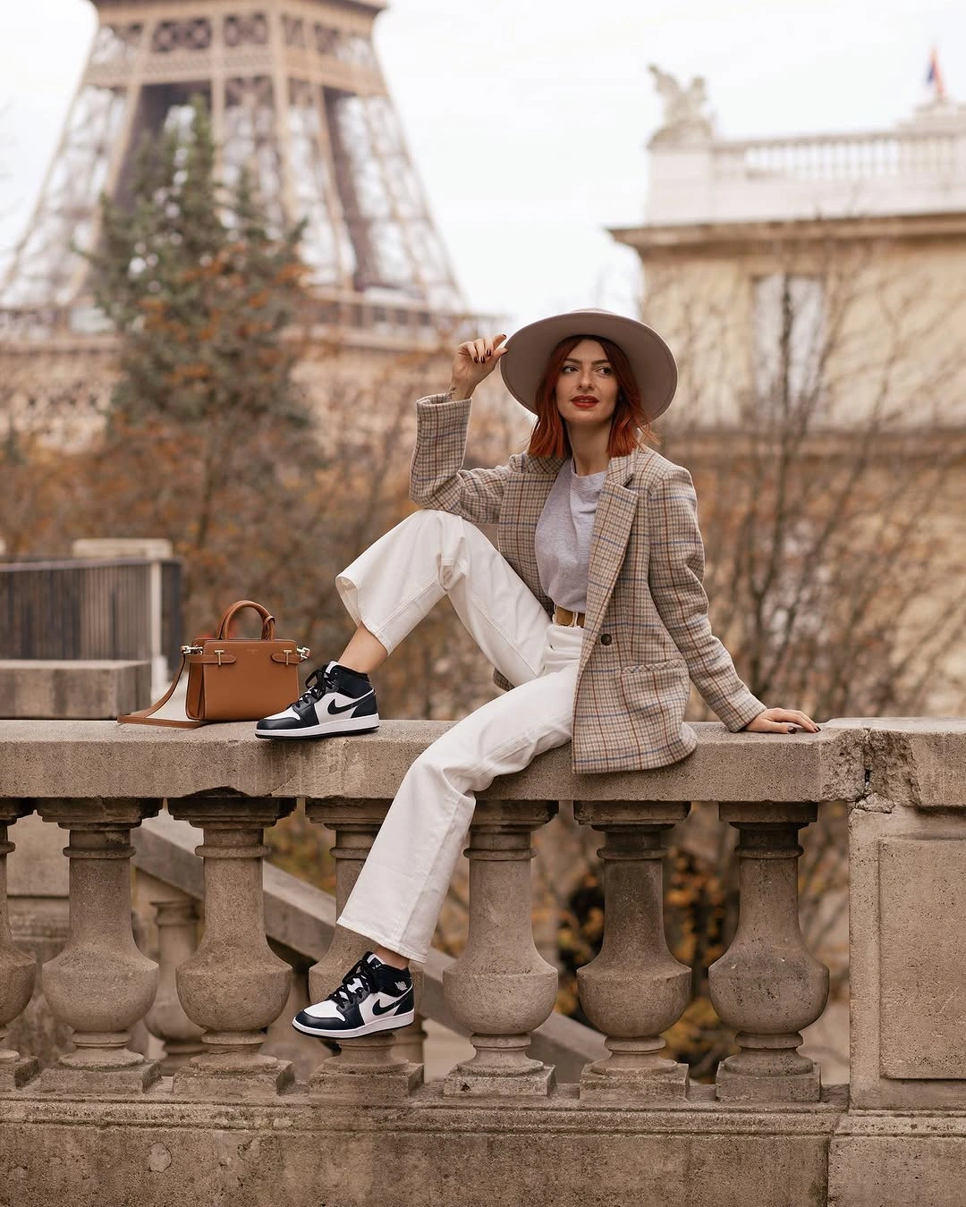 Checked blazer, light top, cropped pale trousers, hat, bag, and sneakers