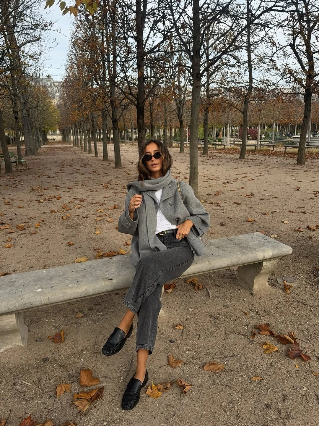 Gray blazer-like coat, gray scarf, gray jeans, and black loafers