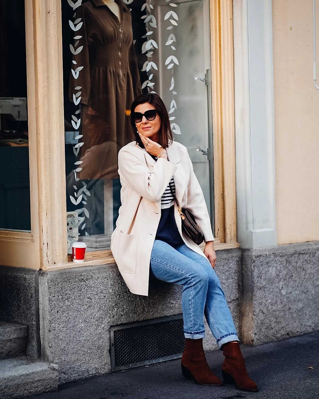 White tailored-looking jacket with jeans and brown ankle boots