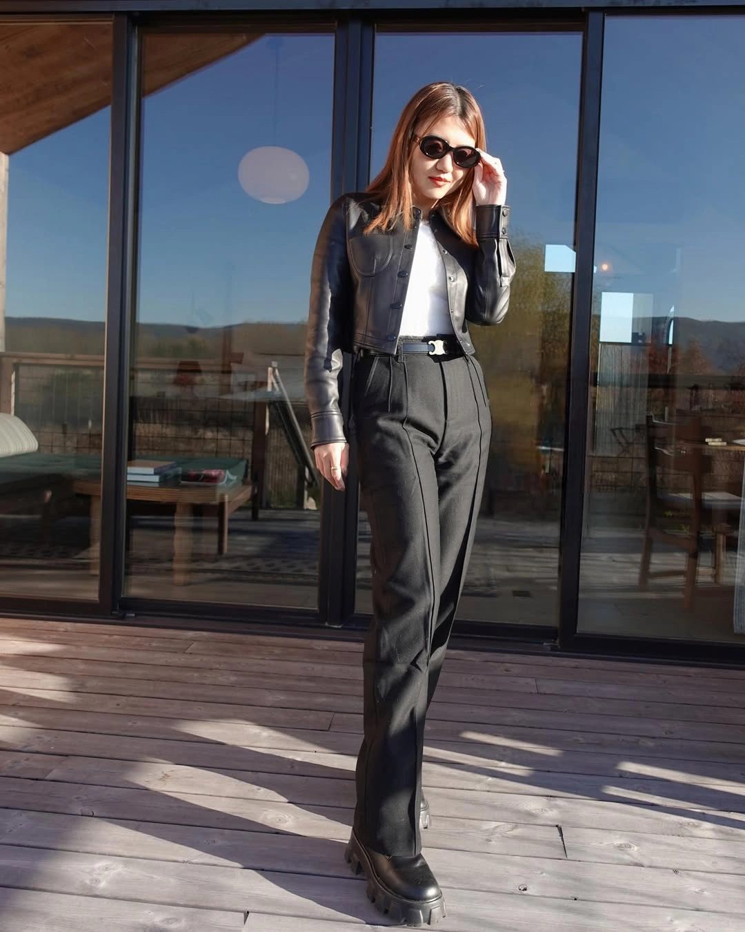 Dark vest over white top with gray wide trousers