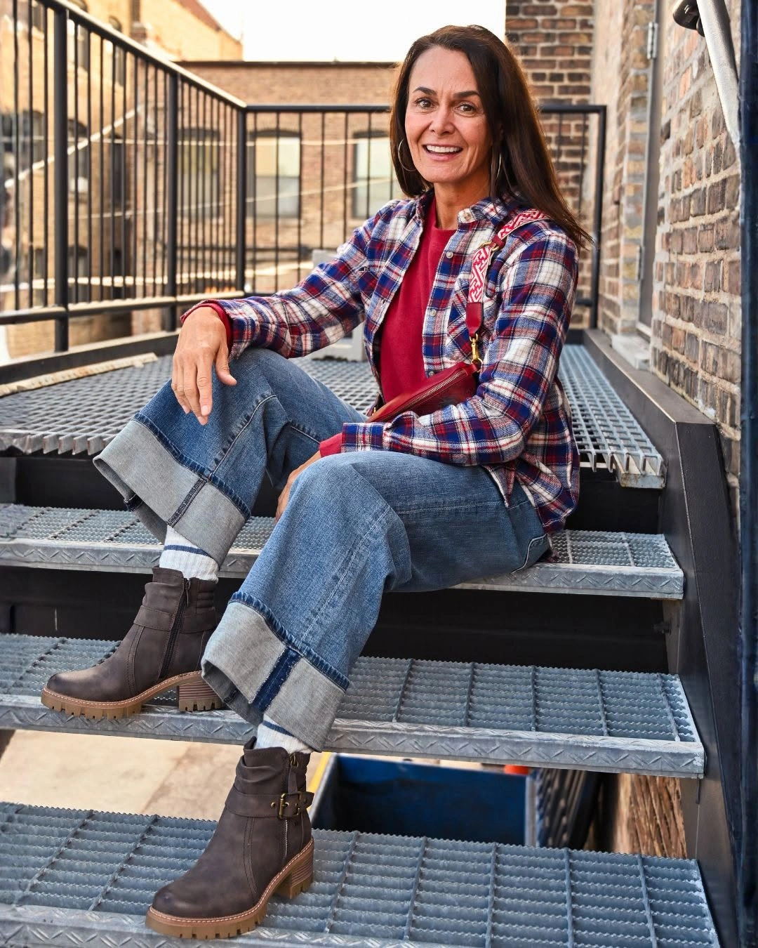 Red and blue plaid shirt with cuffed jeans and brown boots