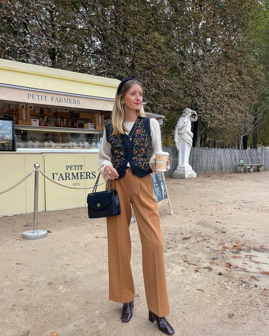 Patterned dark upper layer with tan trousers and black accessories