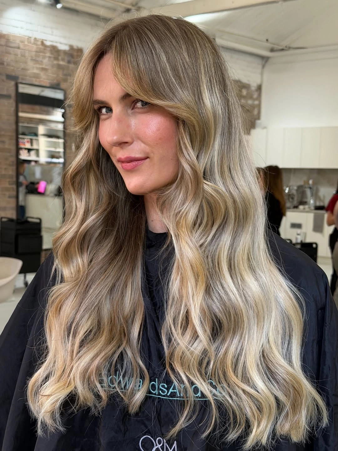 Very long beige blonde waves with darker roots