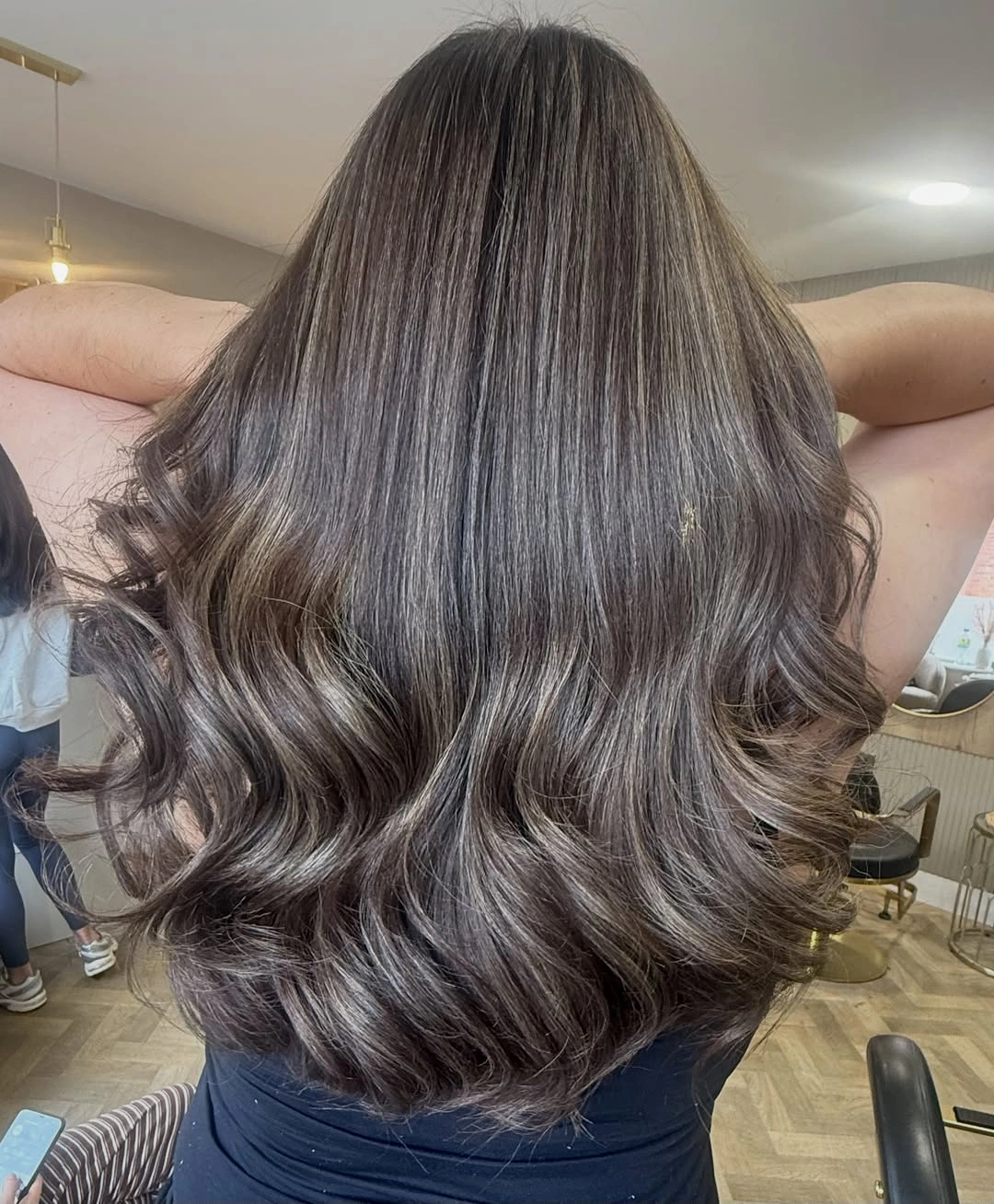 Long smoky ash brown hair with cool lower waves