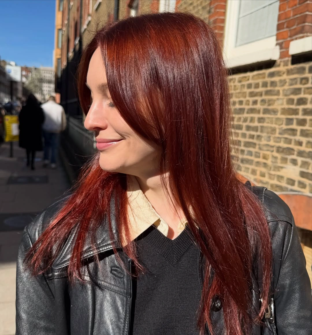 Straight auburn red hair in bright side profile