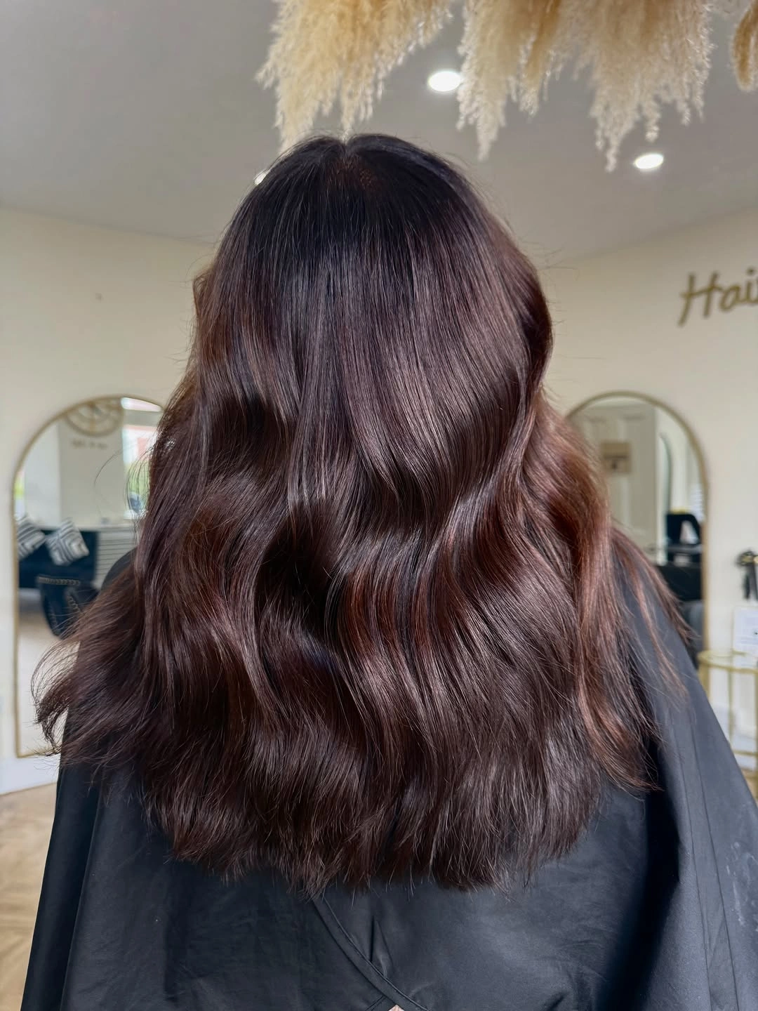 Medium-long dark burgundy brown waves with glossy surface