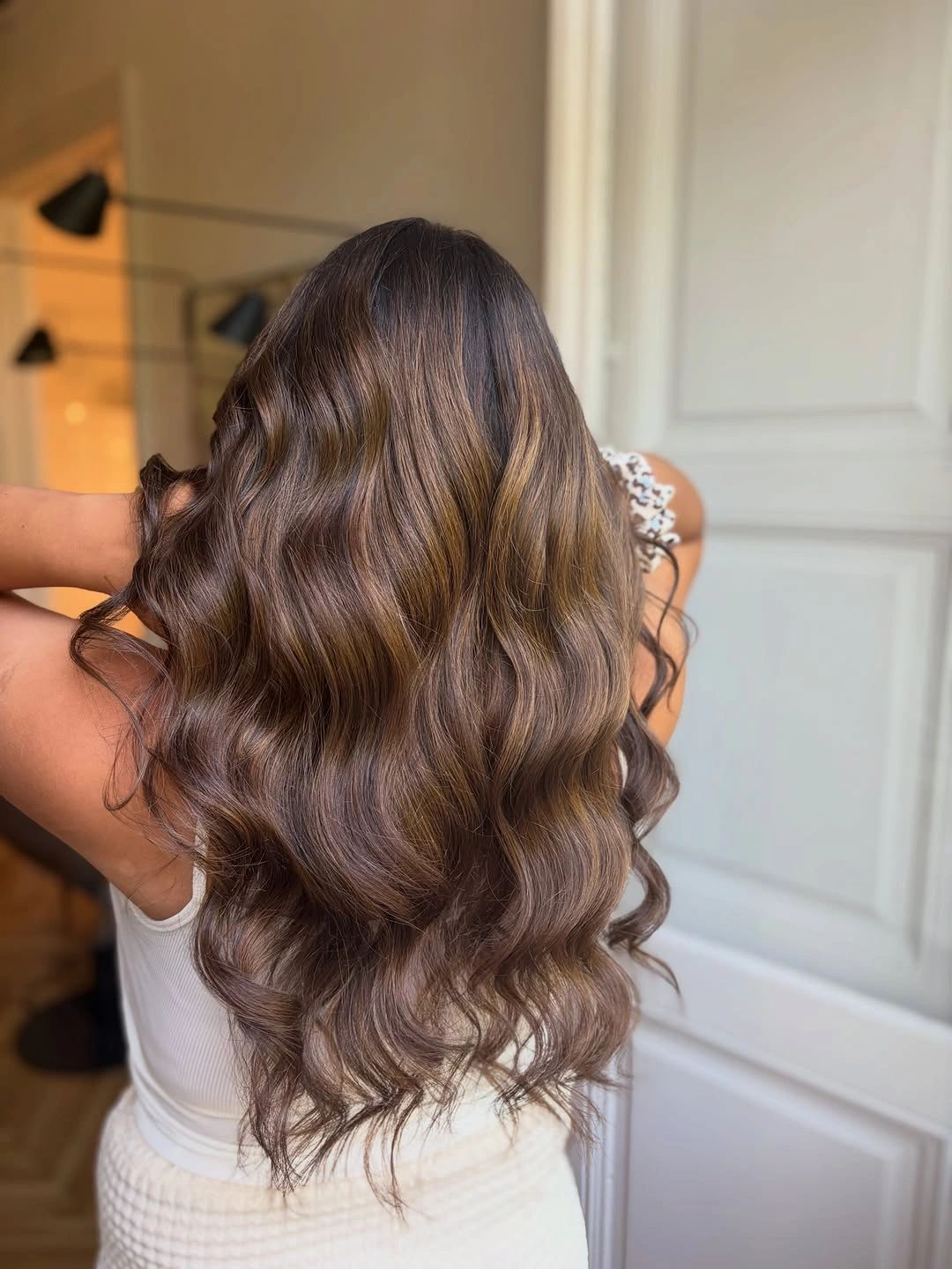 Long warm brown waves with golden caramel sheen