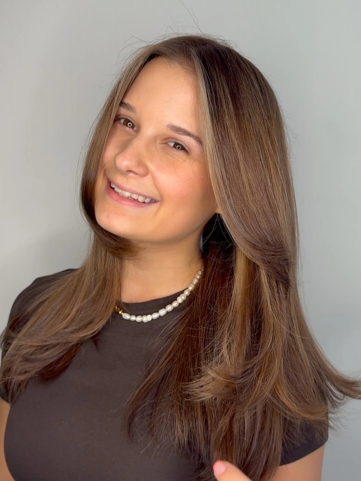Medium brown layered hair with caramel-looking face-framing pieces
