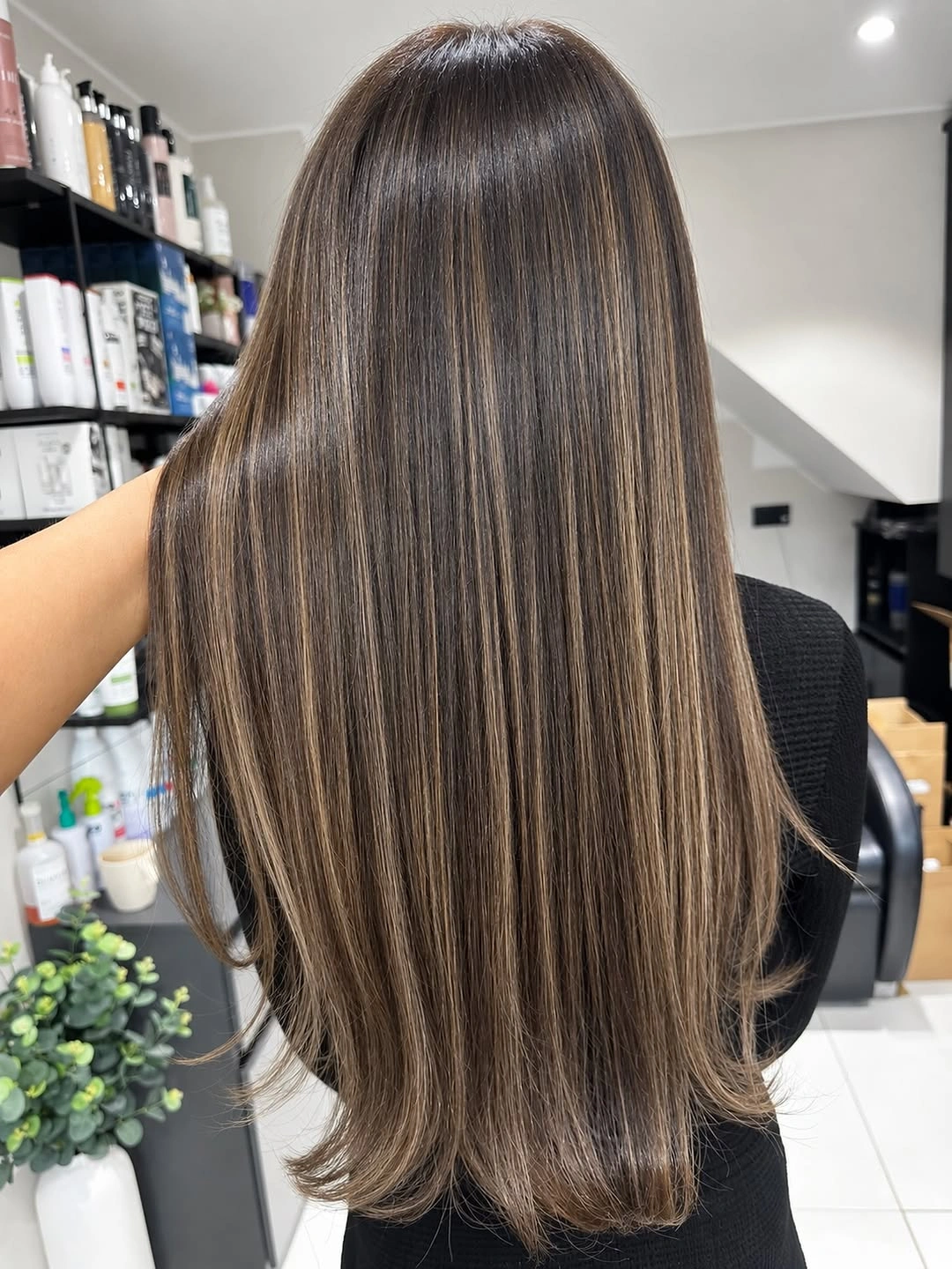 Very long straight brunette hair with fine lightened-looking ribbons