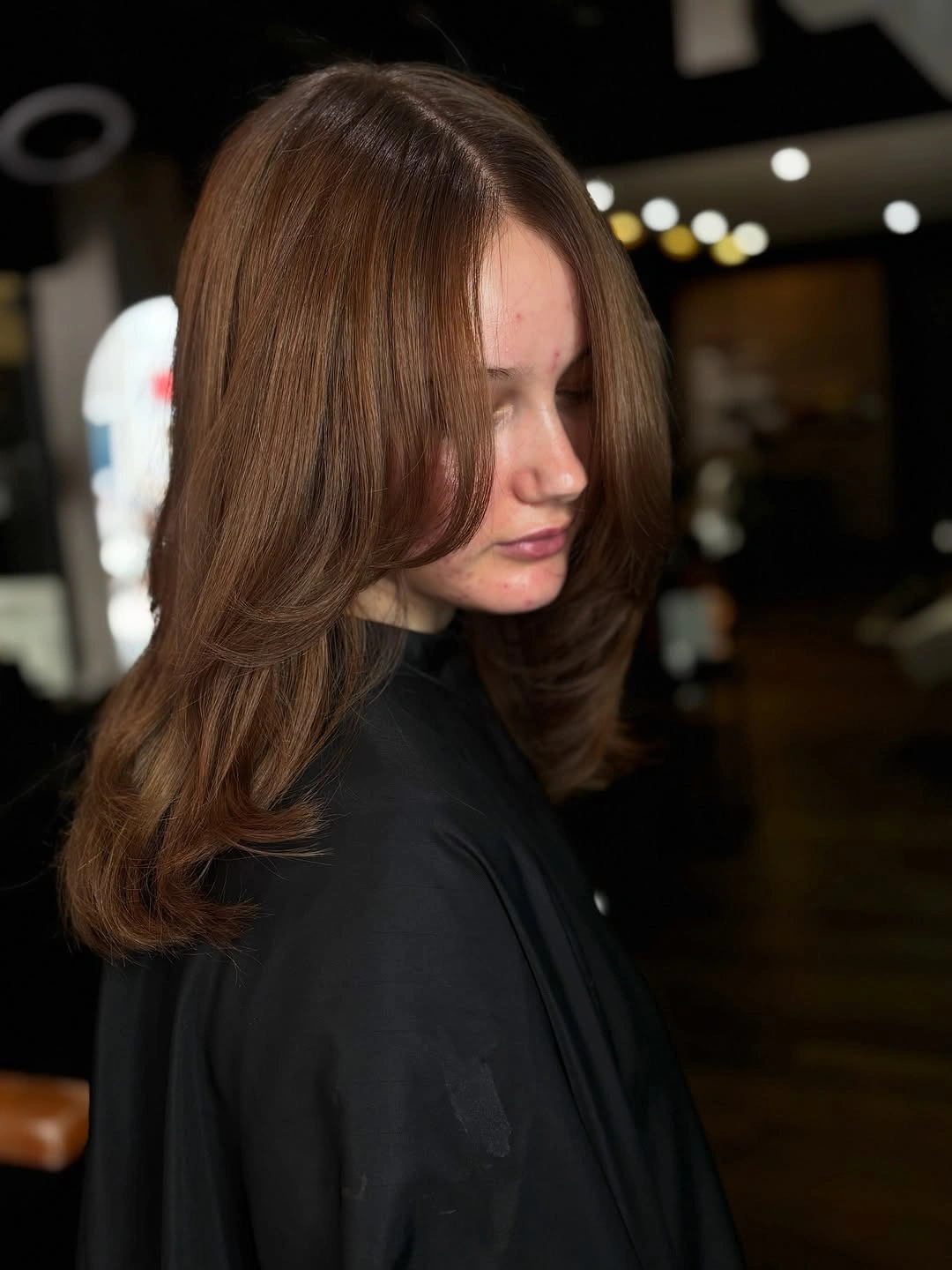 Medium warm brown hair with face-framing layers