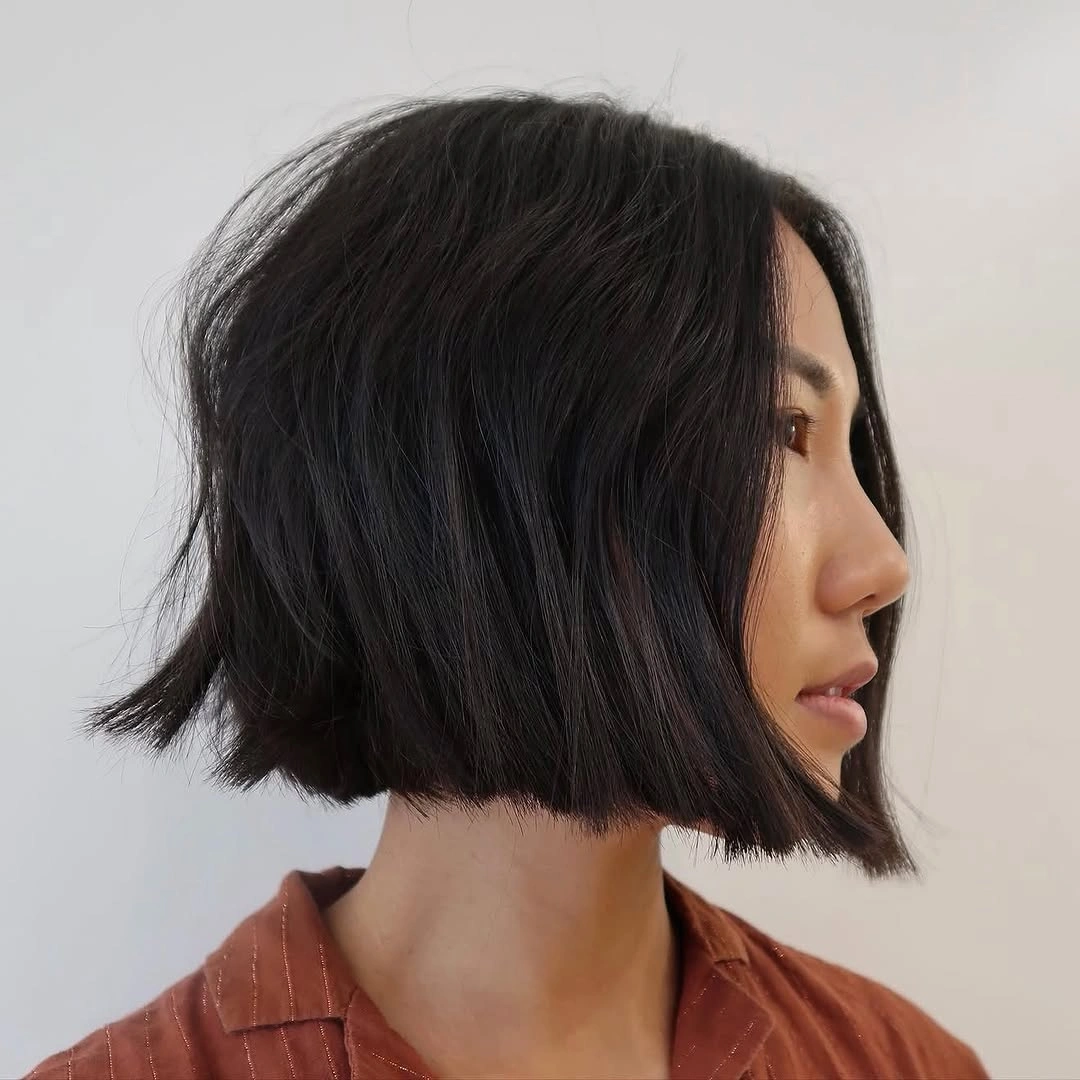 Long dark ash brown waves with side part in salon setting
