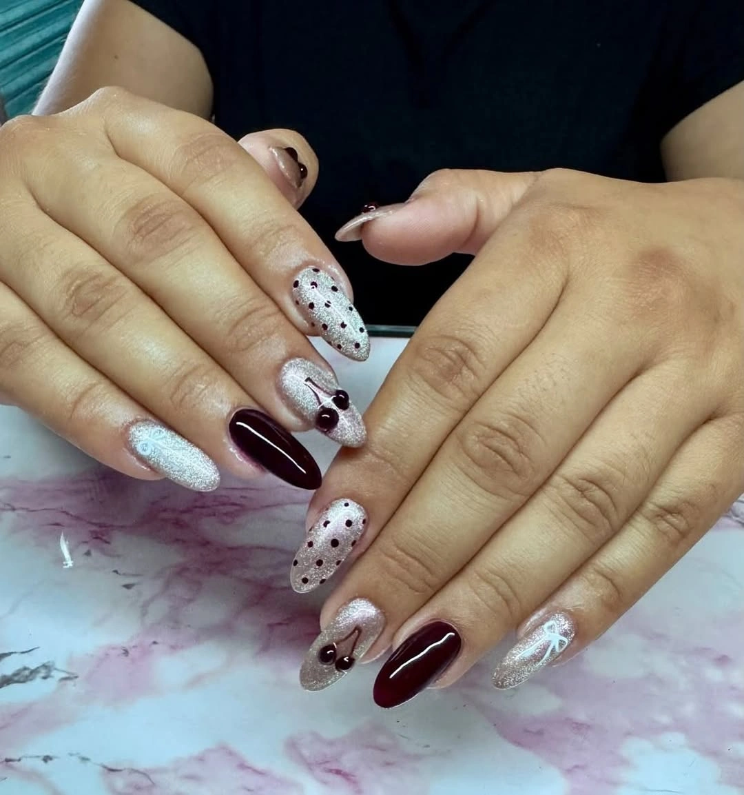 Mixed burgundy, silver shimmer, nude dots, and bow-like accents