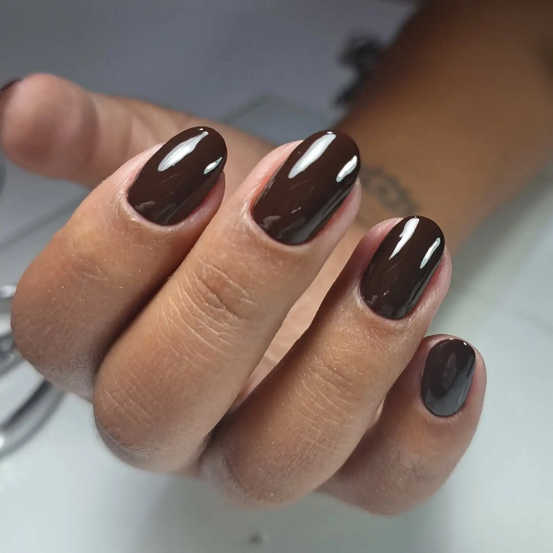 Short rounded dark brown nails with gray-brown accent