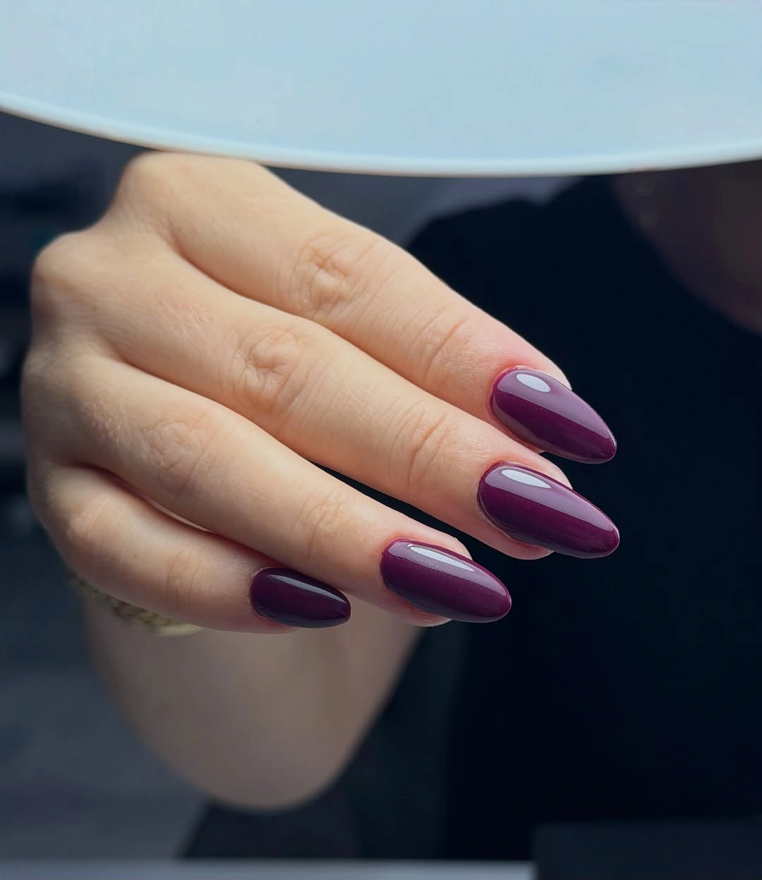 Saturated plum-purple almond nails with smooth reflective highlights
