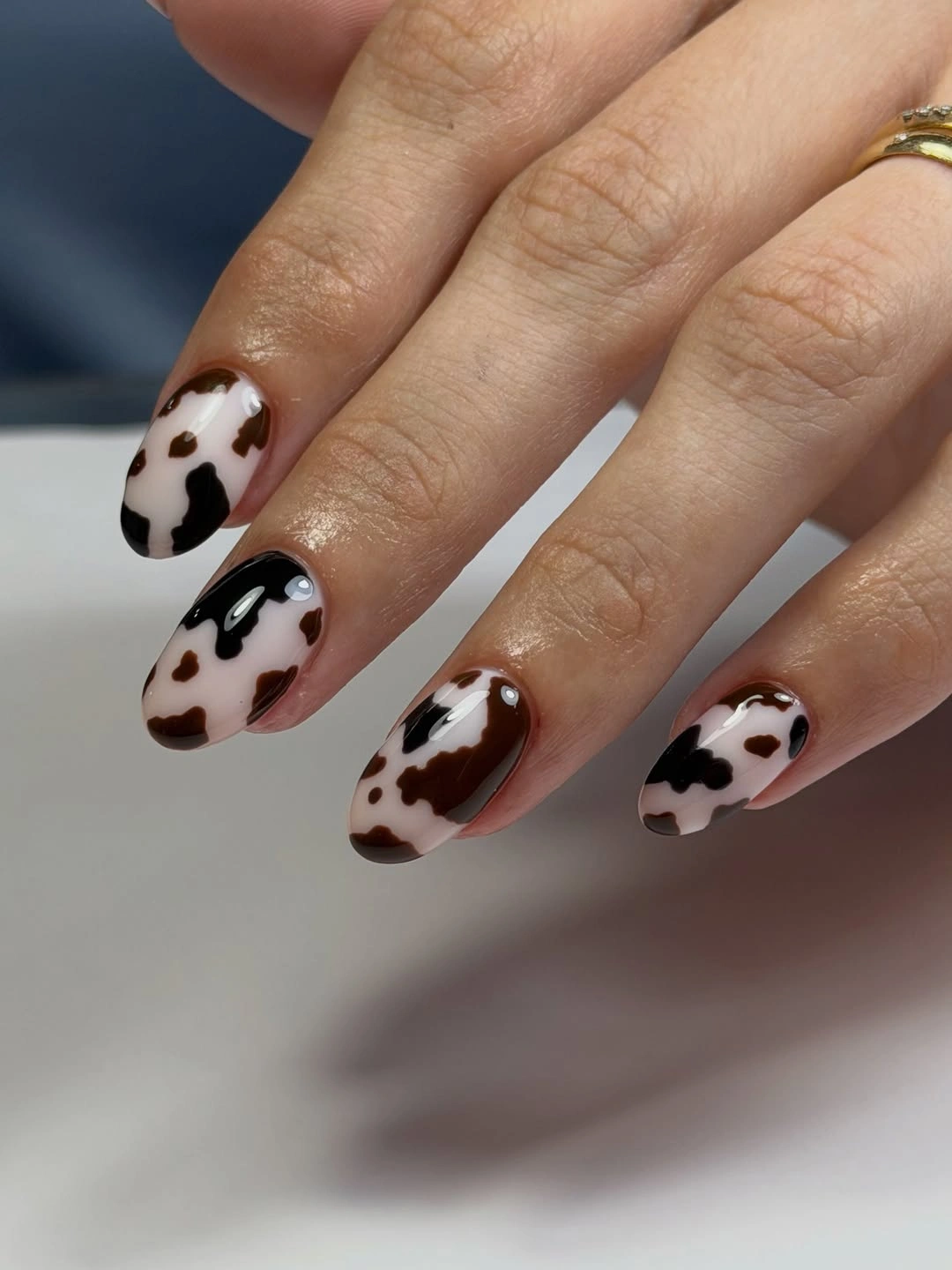 Short oval nails with brown, black, and white spotted pattern