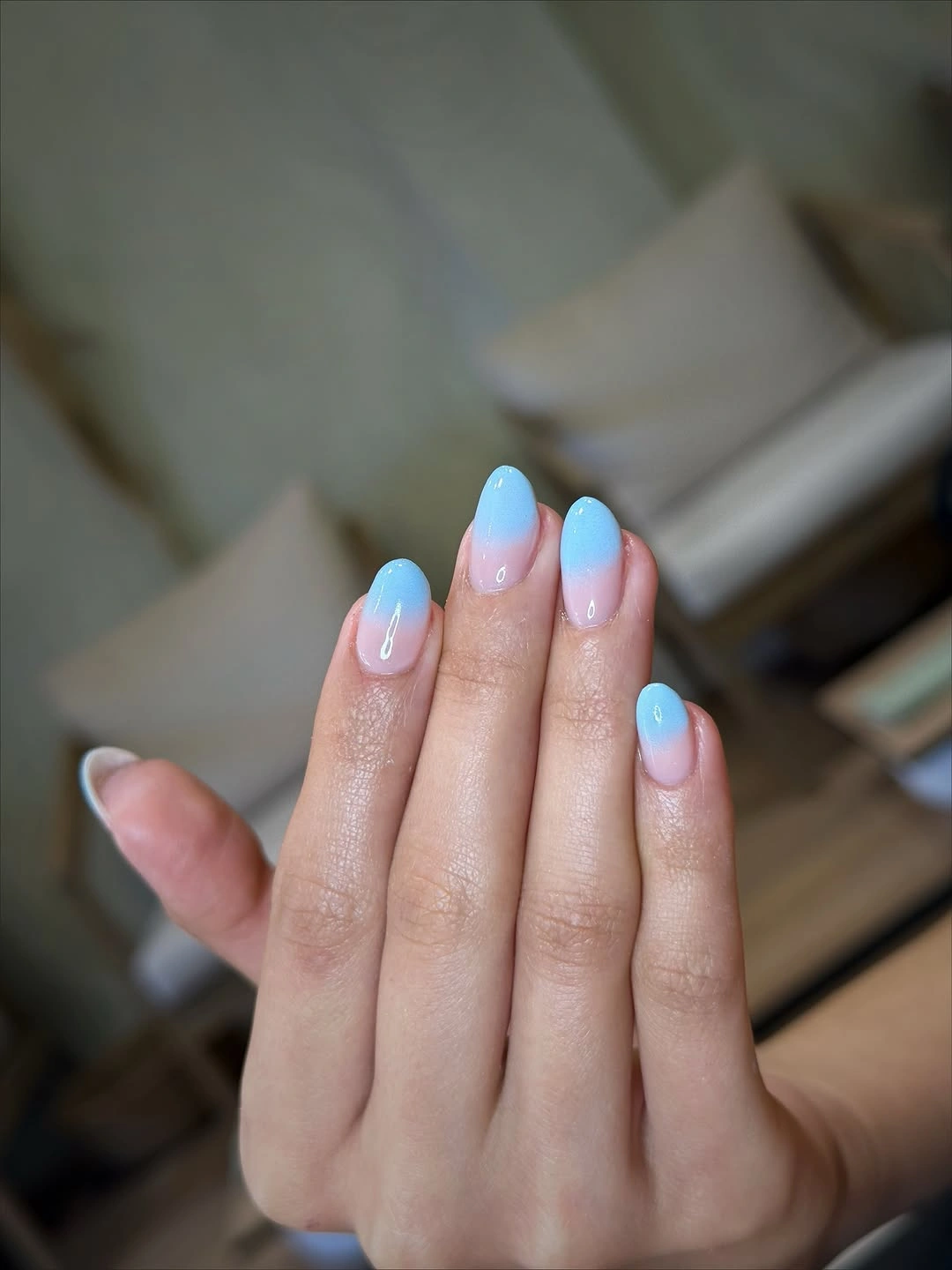 Short almond nails with pale blue tips fading into pink