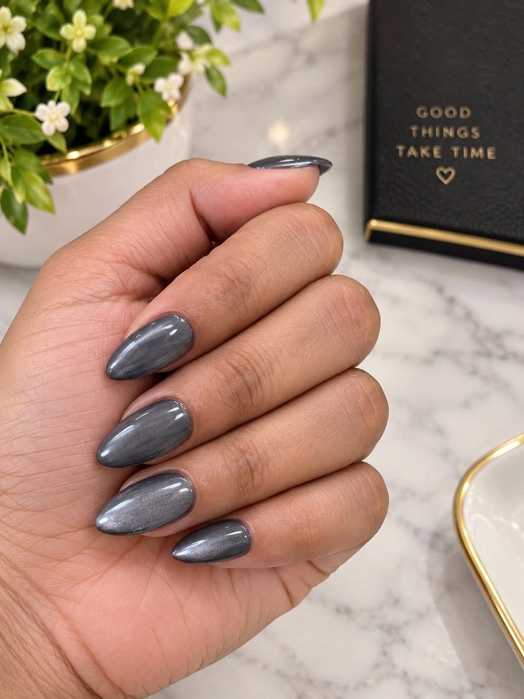 Smoky gray almond nails with metallic-looking reflective shimmer