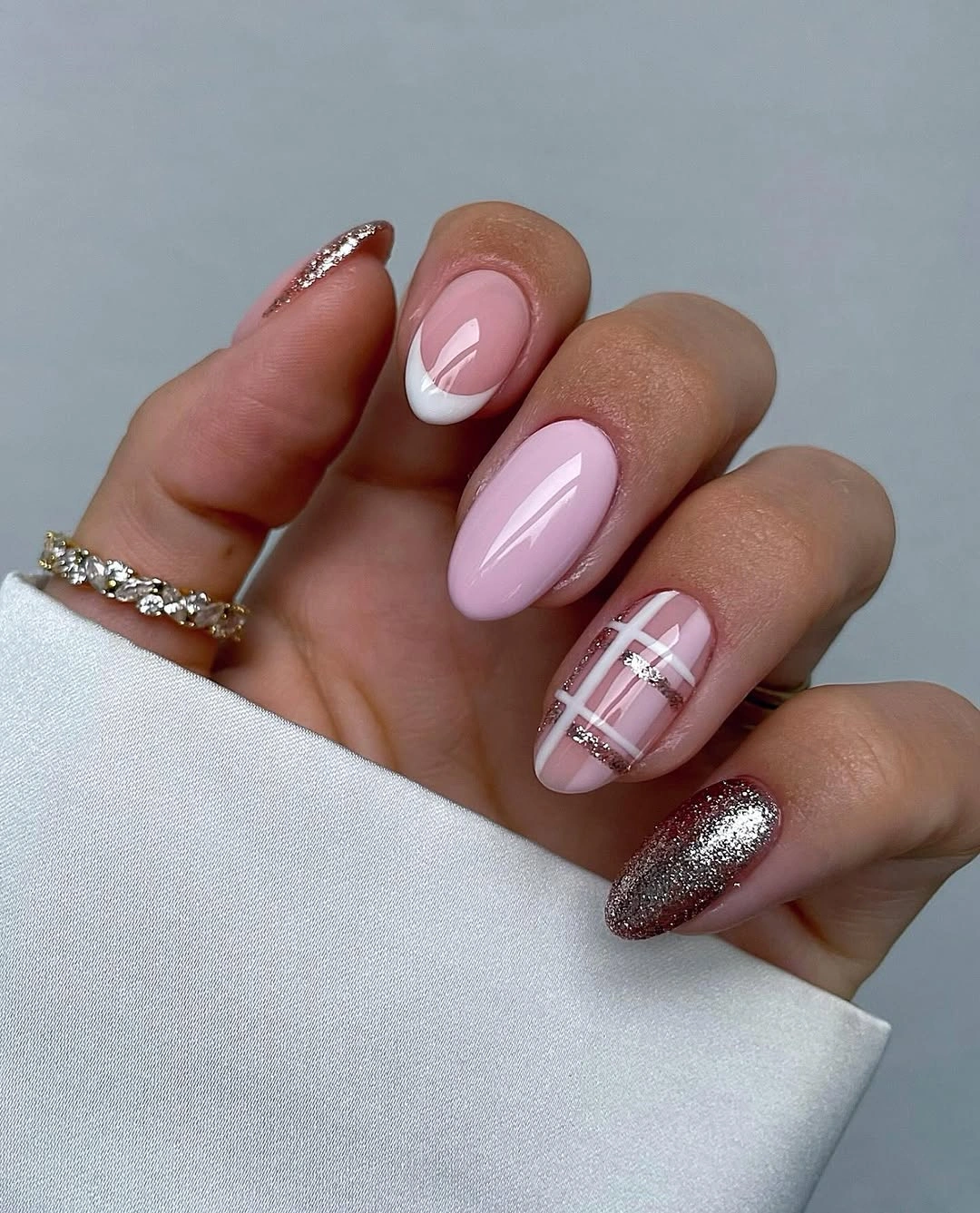 Pink almond nails with white French tip and silver glittering accents