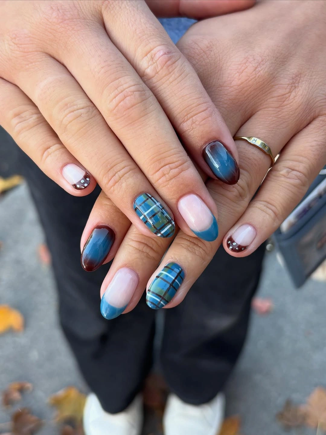 Rounded-square nails with blue French tips plaid and glossy navy accents