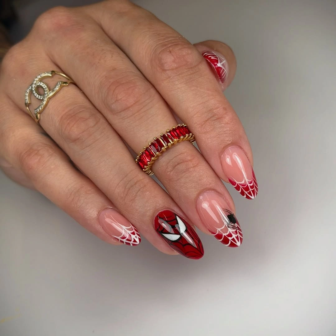 Pink almond nails with red tips and white web-like lines