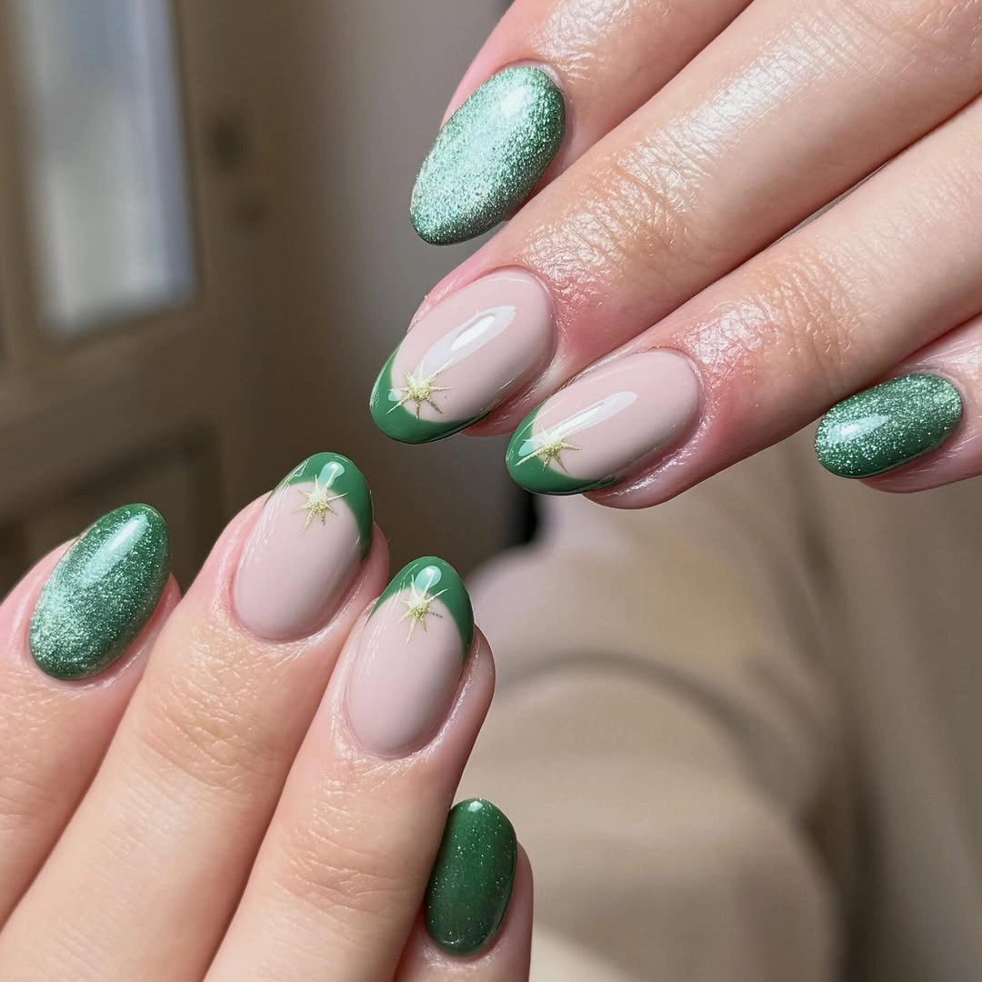 Almond nails with green shimmer solids tips and pale starbursts