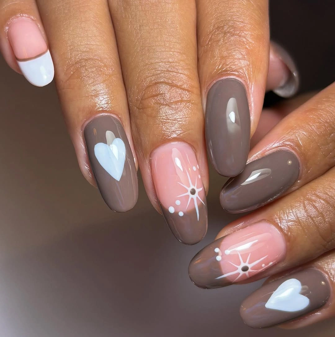 Taupe brown almond nails with white hearts starbursts dots and pink accents