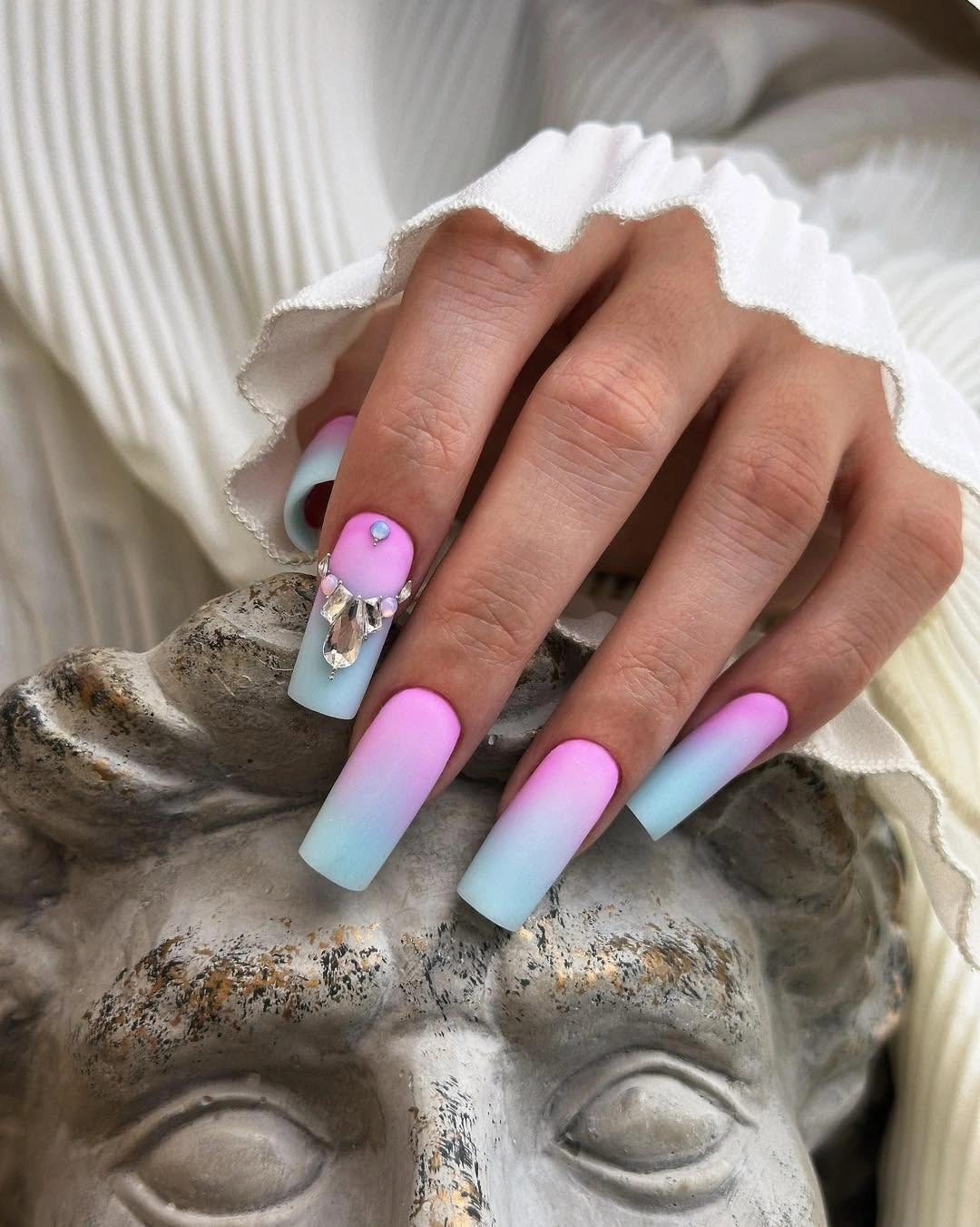 Long coffin nails with pink-aqua gradient and silver-toned raised accent
