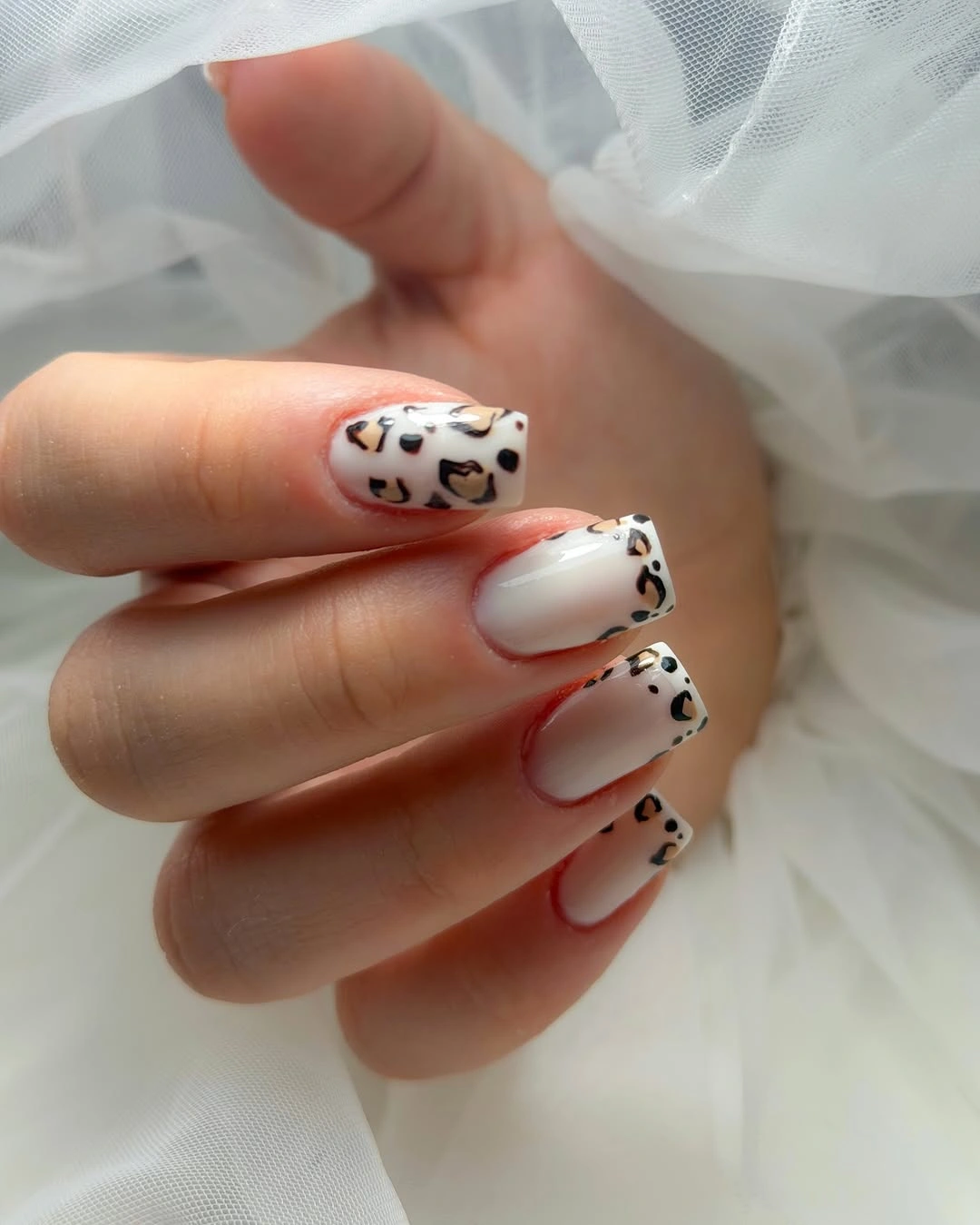 Soft-square milky nails with black and brown leopard-like spots