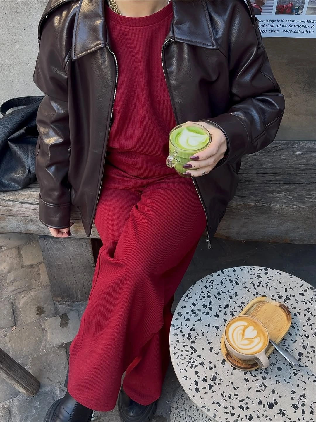 Dark brown jacket, red top and pants, black shoes