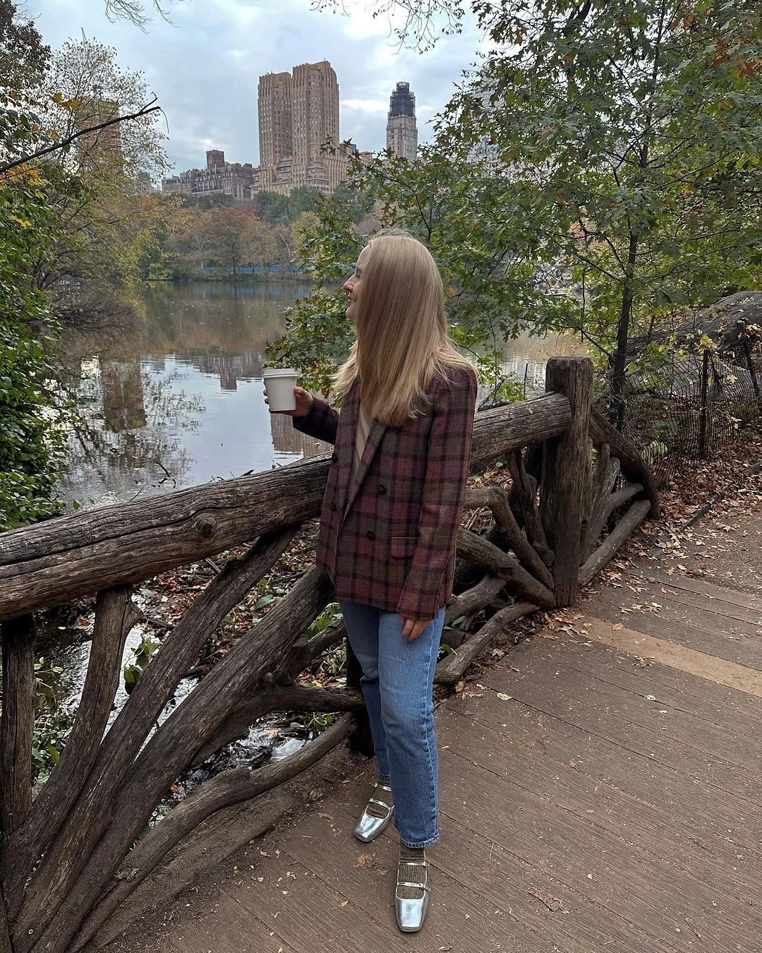 Brown-red plaid jacket, blue jeans, shiny silver shoes