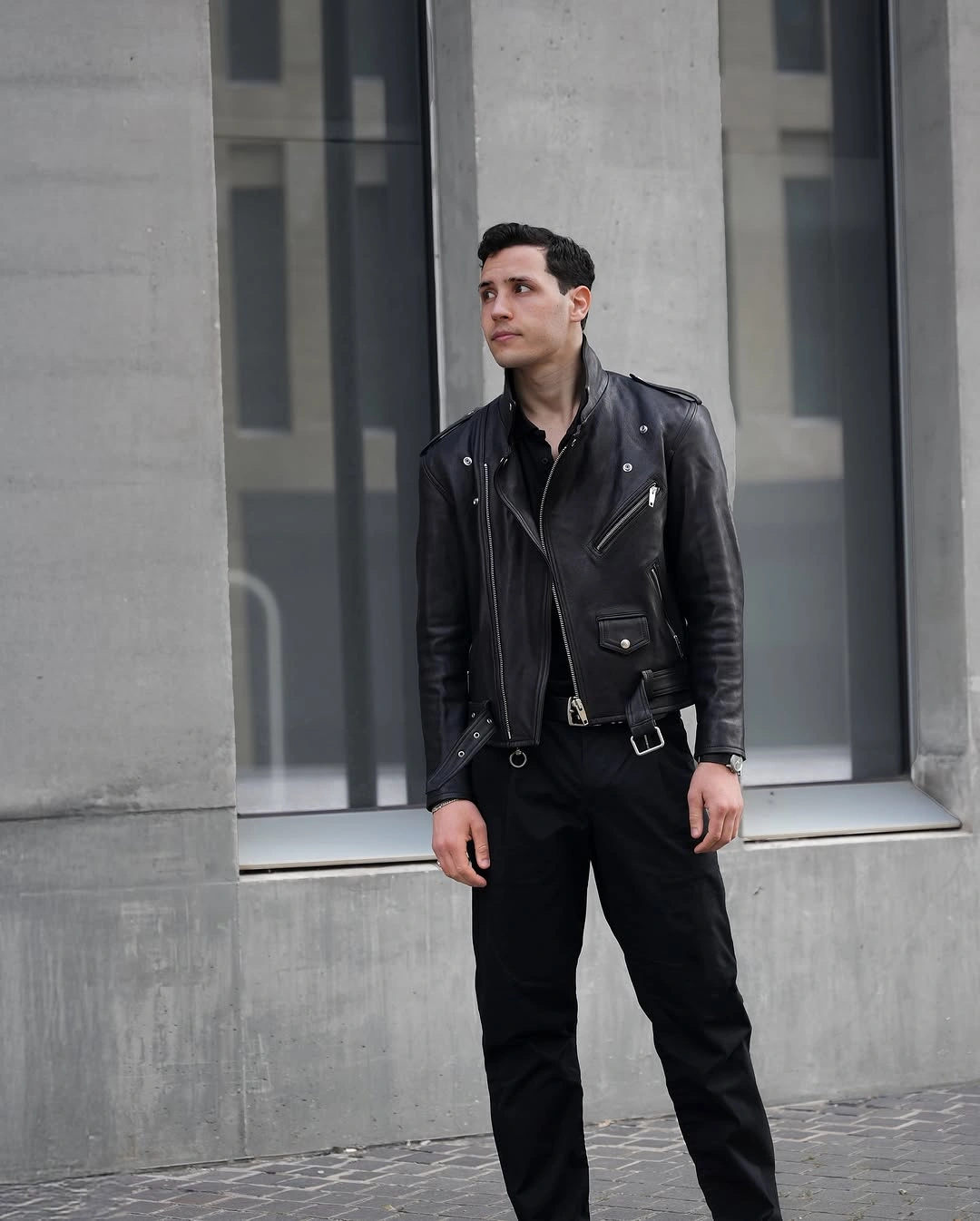 Black motorcycle jacket with loose black trousers